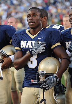 Iwuji putting his hand on his heart for the National Anthem